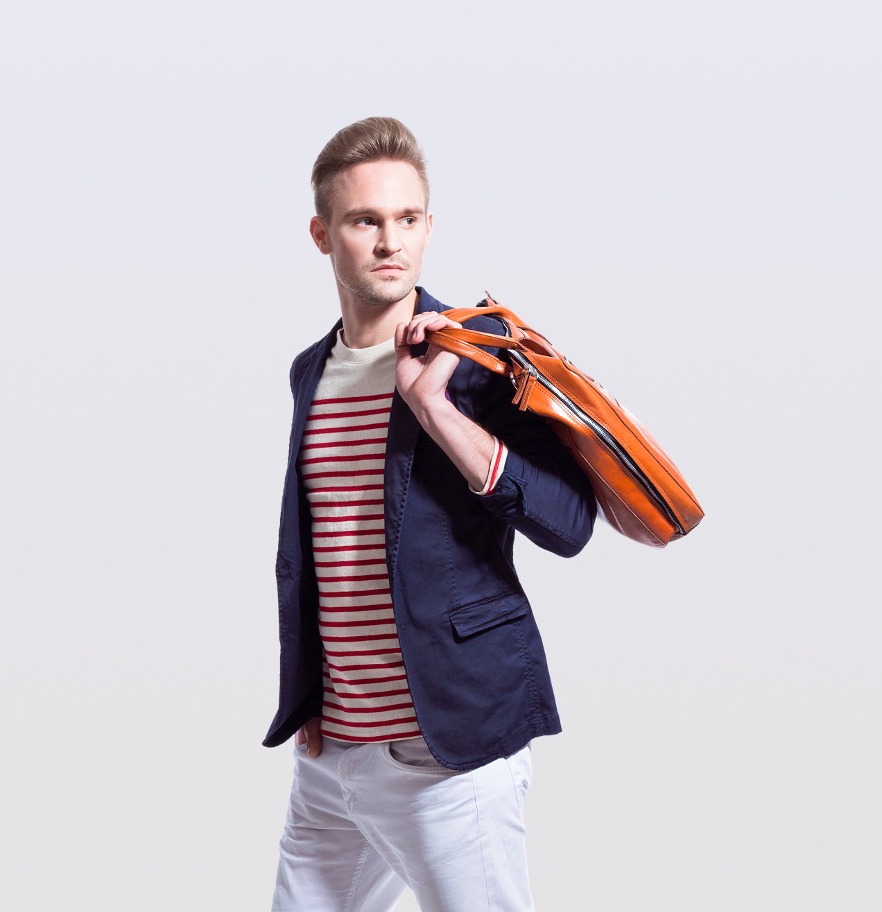 Stylish man carrying orange bag